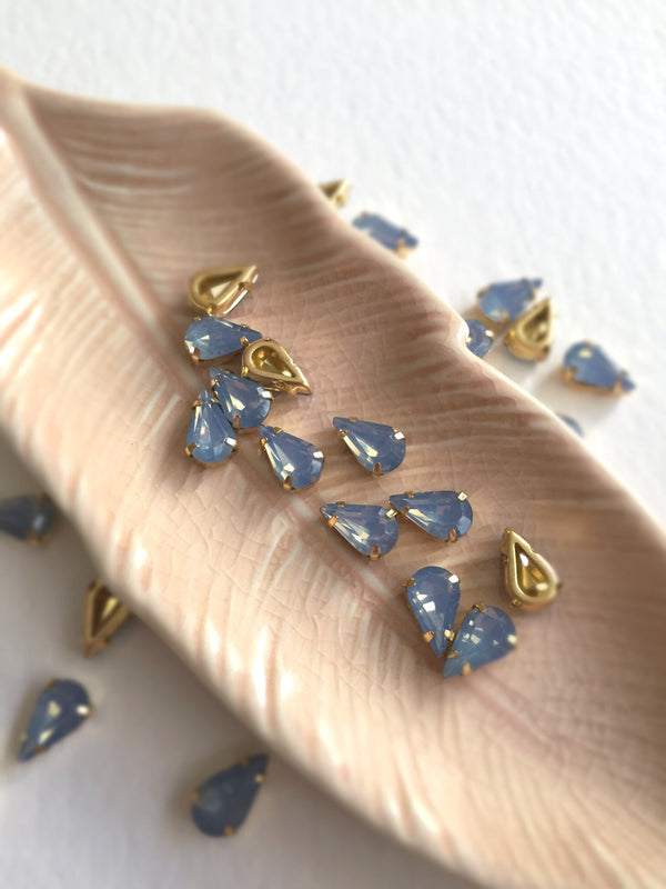 24 x 6x10mm Teardrop Blue Opal Rhinestones in Gold Tone Sew-on Setting (3634)