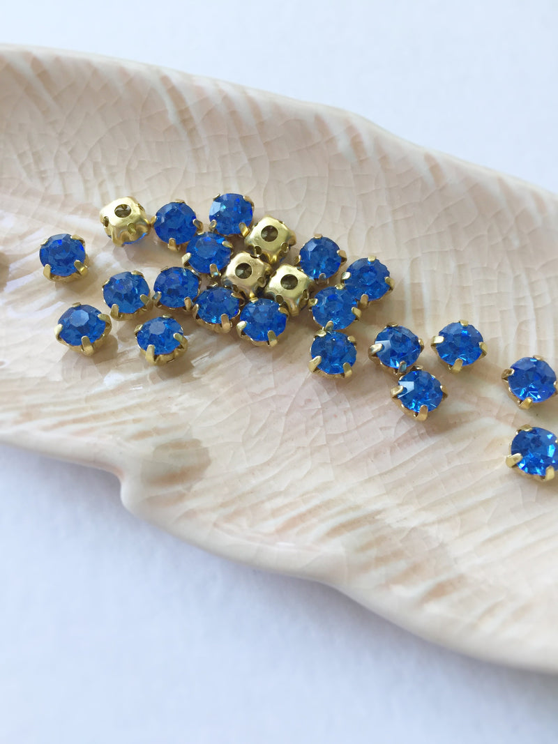 48 x Light Sapphire Glass Rhinestones in Gold Sew-on Setting, 4mm or 5mm