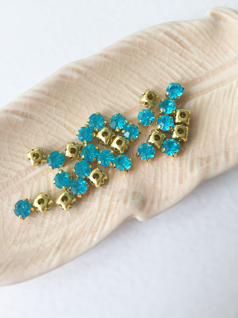 48 x Aquamarine Glass Rhinestones in Gold Sew-on Setting, 4mm or 5mm