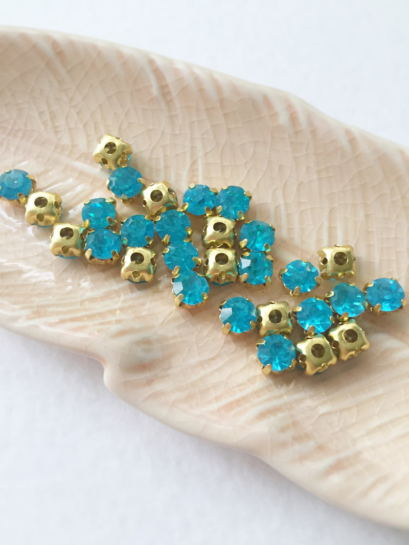 48 x Aquamarine Glass Rhinestones in Gold Sew-on Setting, 4mm or 5mm