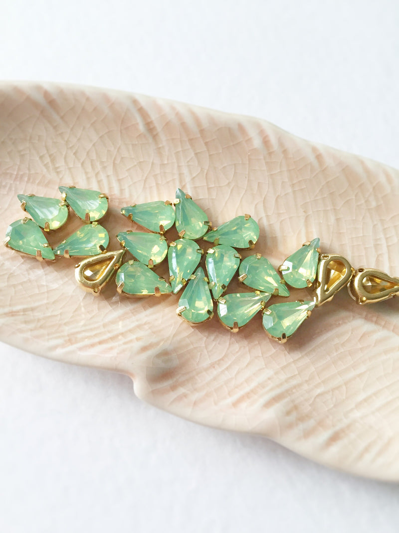 24 x 6x10mm Teardrop Green Opal Rhinestones in Gold Tone Sew-on Setting (3638)