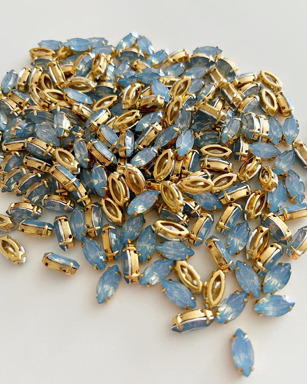 12 x 6x12mm Navette Blue Opal Rhinestones in Gold Tone Sew-on Setting (2777)