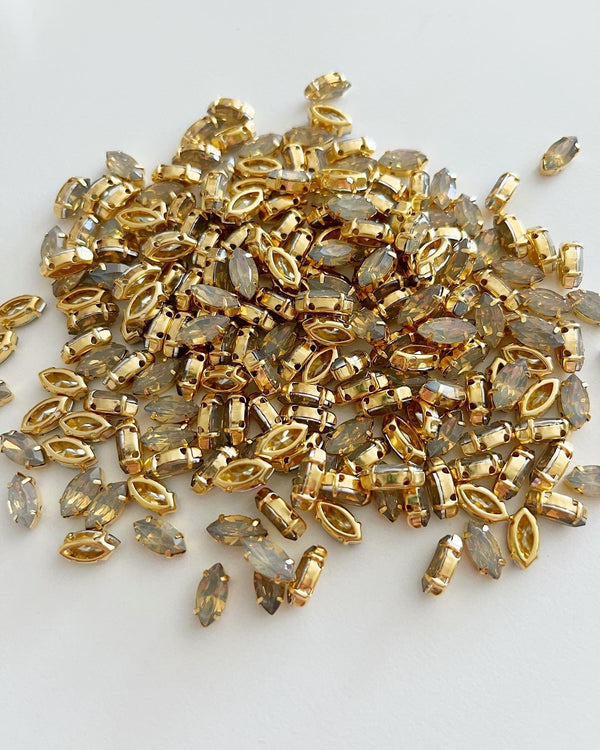 24 x 5x10mm Navette Sand Opal Rhinestones in Gold Tone Sew-on Setting (3627)